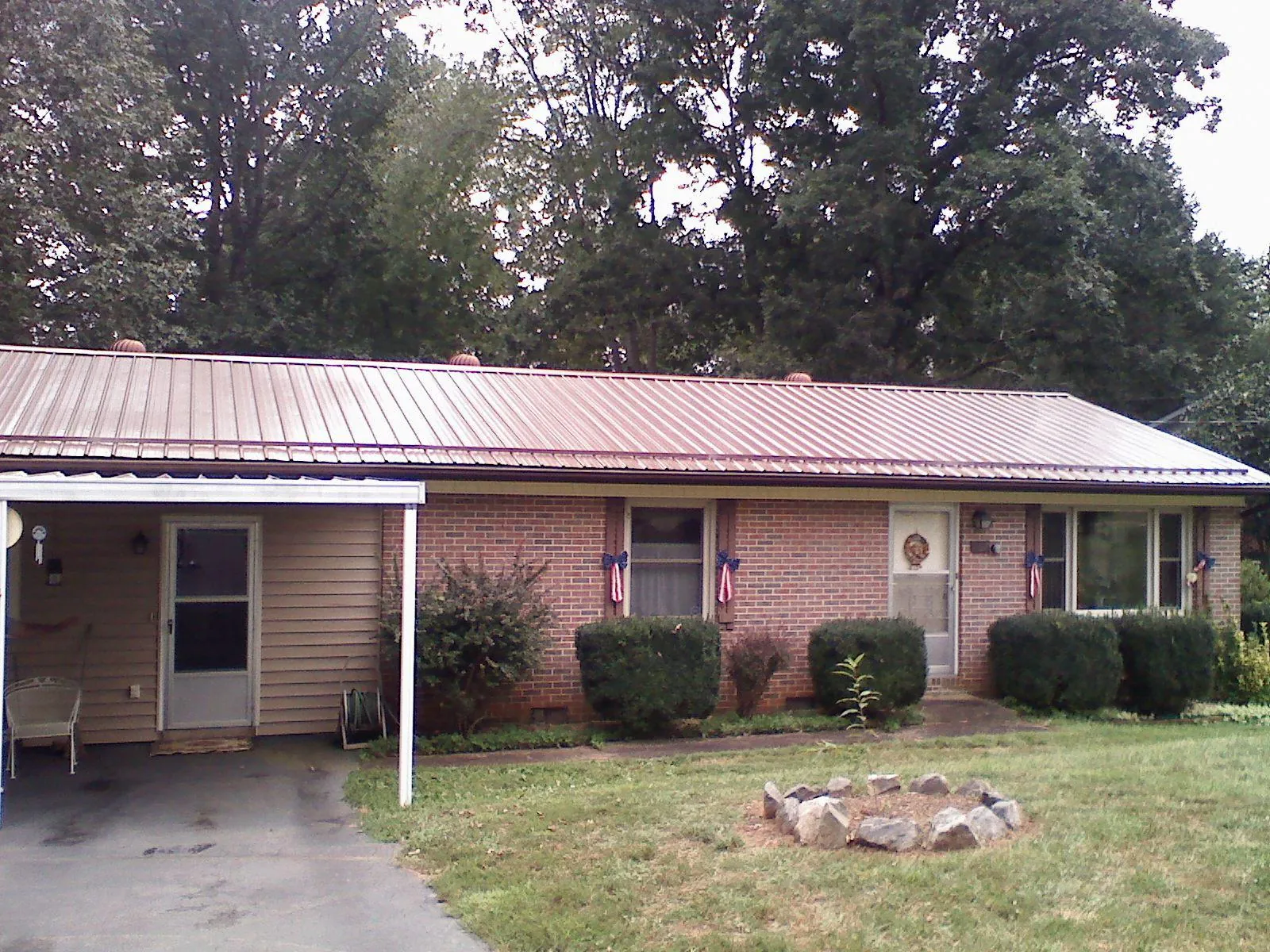Bronze metal roof and carport on a brick ranch home — Roof Repair work by our crew in Pleasant Ridge